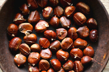 Cast iron pan filled with chestnuts. Top view.