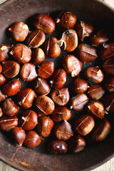Cast iron pan filled with chestnuts. Top view.