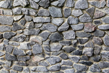 Wall of natural old stones. Granite masonry for natural background