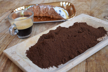 espresso coffee  with a cannolo and gound coffee