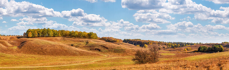 Fototapeta na wymiar Autumn landscape, panorama, background - view of the valley with meadows and wooded hills, horizontal banner