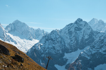 mountain landscape, ski resort, chairlift, pointed mountain peaks in snow, permafrost