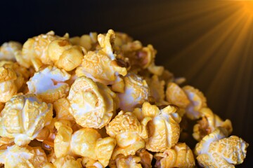 Popcorn on a black background is lit up with elegant spotlights.