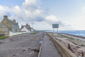 A Scottish seatown village road cover of stones after a major storm 