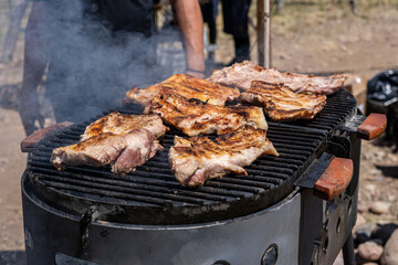 Traditional Argentine asado on the grill with charcoal and fire cooked in the open air