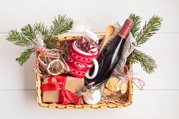 Refined Christmas gift basket for culinary enthusiats with bottle of wine and mulled wine ingredients. Corporate hamper or personal present for cooking lovers, foodies and gourmands.