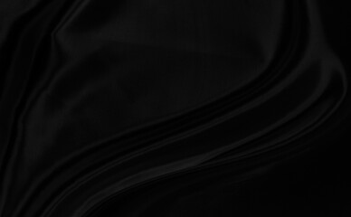 Black gray satin dark fabric texture luxurious shiny that is abstract silk cloth background with patterns soft waves blur beautiful.