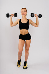 Fototapeta na wymiar Portrait of seductive young woman looking at camera with muscular body ready for a workout