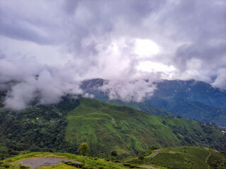 Obraz premium green mountain with dramatic sky at morning from hill top