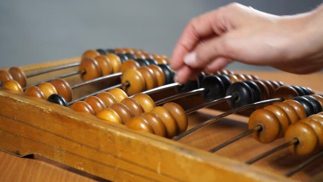 Video shows old wooden abacus. 
