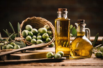 Olive oil with fresh olives on rustic wood - obrazy, fototapety, plakaty