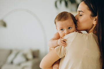 Mother with her baby girl at home