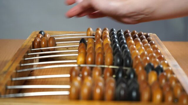 Video shows old wooden abacus. 