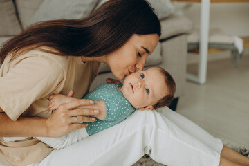 Mother with her little baby girl at home