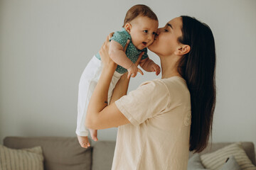 Mother with her little baby girl at home