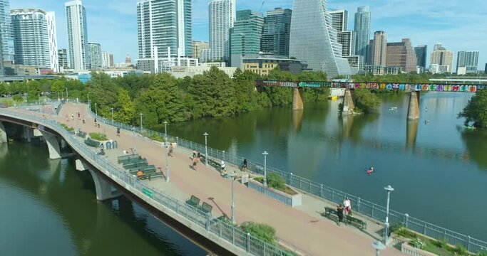 Austin Texas Pedestrian Bridge on the Colorado River and Lady Bird Lake Downtown Skyline View with Kayaks (Aerial Drone View in 4k)