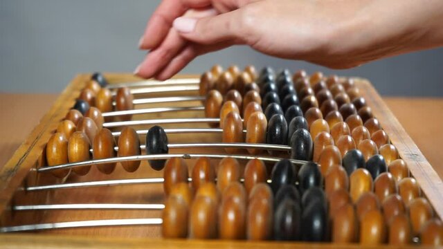 Video shows old wooden abacus. 