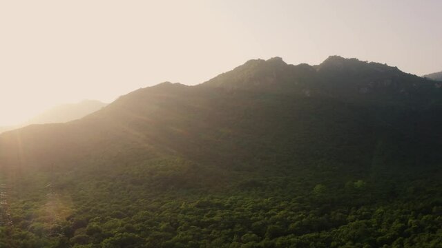 Aerial view of green hills with sunshine covering the landscape in Margalla Hills Islamabad, Pakistan