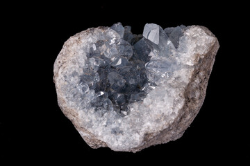 Celestine mineral stone macro on microcline on black background