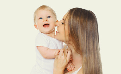 Portrait of happy cheerful smiling mother and baby playing together on a white background