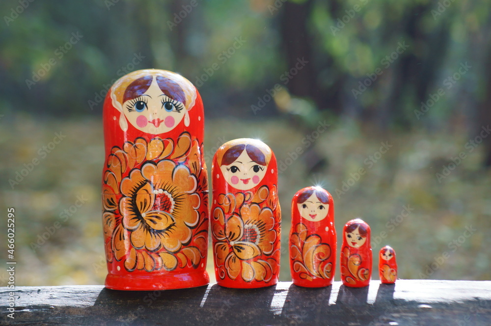 Wall mural Photo of nesting dolls standing in one row. Close-up.