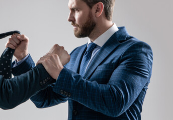 Physical fighting between professional man and male employee grey background, confrontation