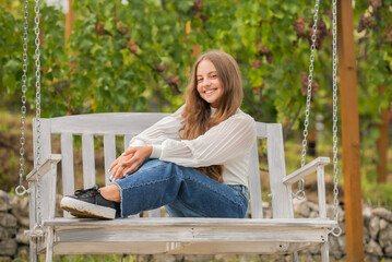 smiling child sit on swing outdoor, playground