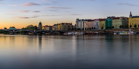 Fototapeta na wymiar Prague's waterside by the Vltava river called Prazska naplavka in twilight.