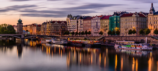 Prague's waterside by the Vltava river called Prazska naplavka in twilight.