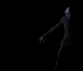 Obraz na płótnie Canvas 3d Illustration of a Nosferatu style Vampire with glowing eyes standing half in shadow