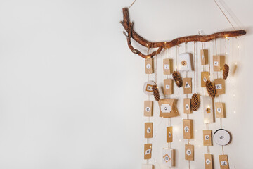 Advent calendar in scandinavian style hanging on the wall. Space for text.