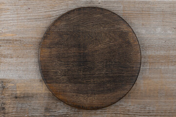 Empty cutting board on a wooden table. Space for text.