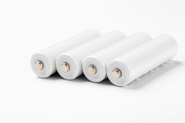 AA size alkaline batteries on a white background. Several batteries in a row.