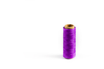 A coil of purple thread. Spool of colored threads on a white background. Waxed sewing thread for leather crafts.