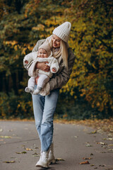 Obraz premium Mother with little baby daughter in autum park