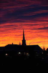 Obraz premium Silhouette of a church at sunrise, Sunrise in the neighbourhood, Calgary cityscape