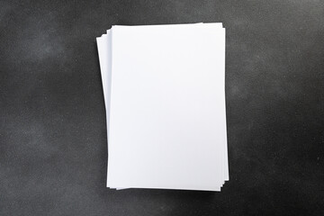 Blank flyer poster A4 paper isolated on dark gray to replace your design