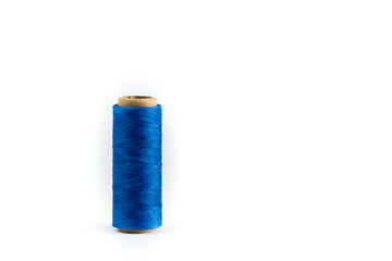A coil of blue thread. Spool of colored threads on a white background. Waxed sewing thread for leather crafts.