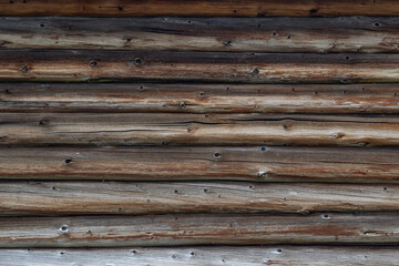 Obraz premium Lines of Wooden Cracked Logs Background Wood Texture Of Cabin Wall