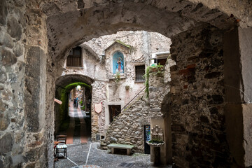 One of the many tunnels and winding narrow alleys in the medieval walled village of Dolceacqua, Italy.