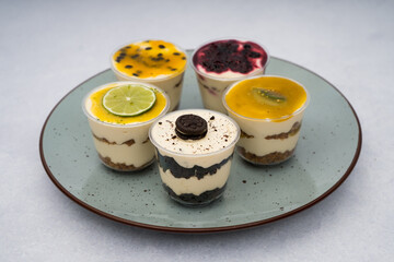 close up of desserts with different flavors on a plate with a marble background
