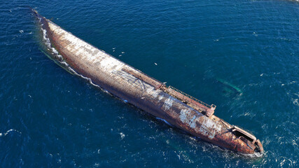 Aerial photo of capsised abandoned ship near shore