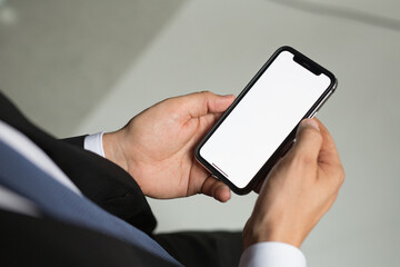 businessman man in a jacket and suit holds a smartphone in his hands. Electronics are in human hands. Concept - digital era