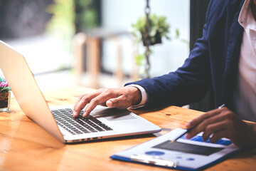 Business man analyzing business price chart on the table at the conference room
