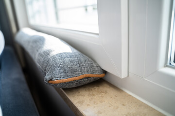 Draft Excluder Under Window Blocking Cold Air - obrazy, fototapety, plakaty