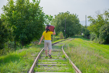 an old man in a yellow t-shirt runs on the rails