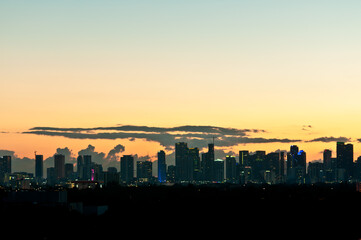 Plakat front view of Miami skyline in silhouette, as sunrise begins the tropical day