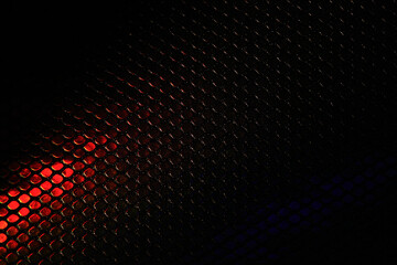 Abstract metallic hexagon background black with red. A red ray of light on the texture of the...