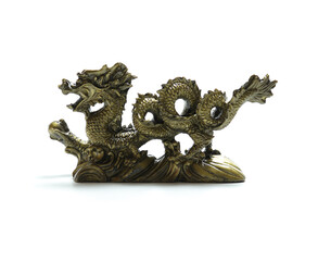 figurine of a dragon holding a pearl in its paw on white background