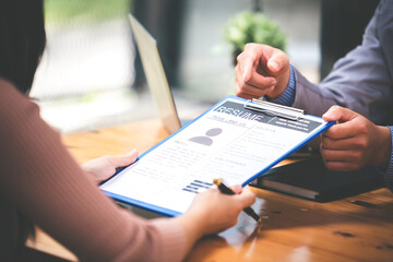 Woman submits her employer's resume to review job applications. Concept showcases her ability to get the company to agree on the position.